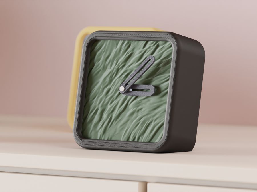 A textured green desk clock with brown bezel, angled hands, on a cabinet