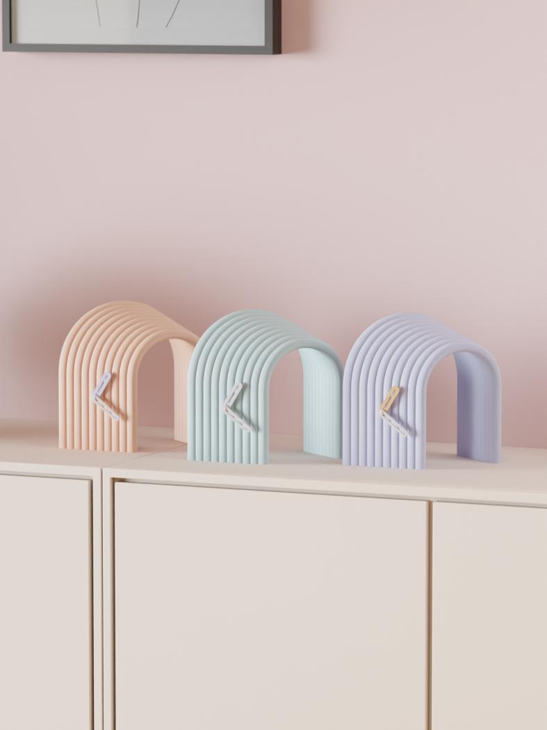 Three tall arched clocks in peach, sage and lavender, ridge-printed